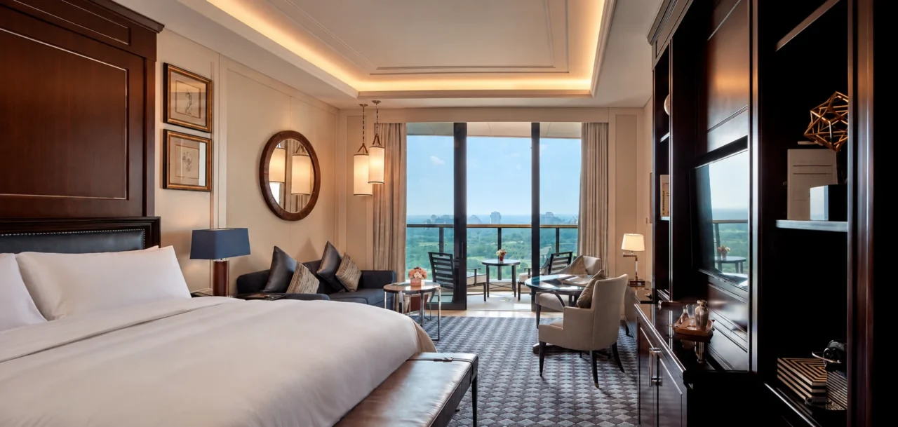 Hotel guestroom with coordinated bedside and pendant lighting